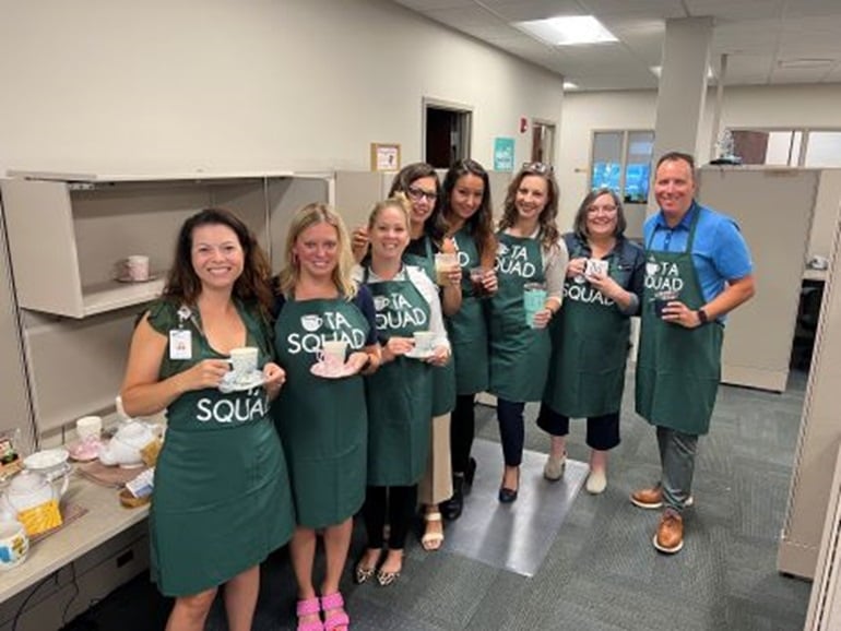 A group Select Medical corporate employees enjoying tea together.