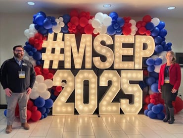 Two Select Medical veterans smiling for a picture at a company conference.