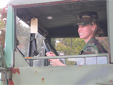 Current Select Medical employee, Blair Ciccocioppo, sits in a military vehicle in uniform in a throwback picture of her days of service.