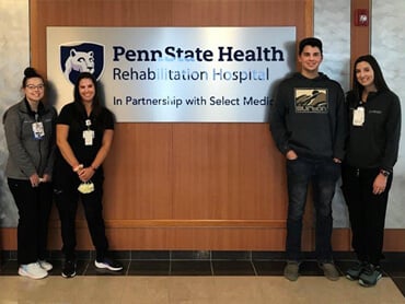 Billy Blatt stands with his therapists.